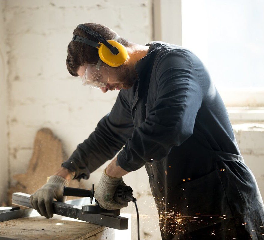 Men with a custom ear protection while working in noisy environment